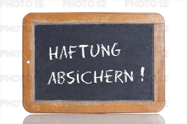Old school blackboard with the words HAFTUNG ABSICHERN!