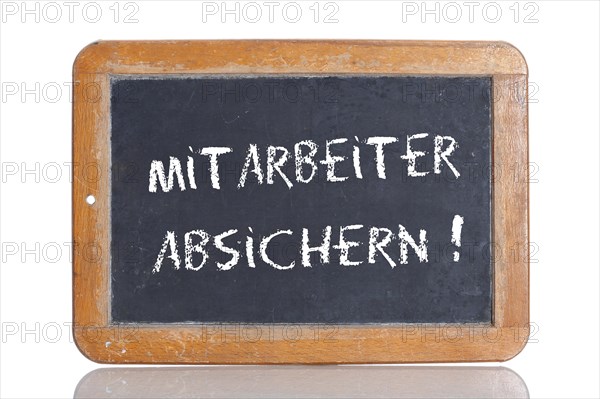 Old school blackboard with the words MITARBEITER ABSICHERN!