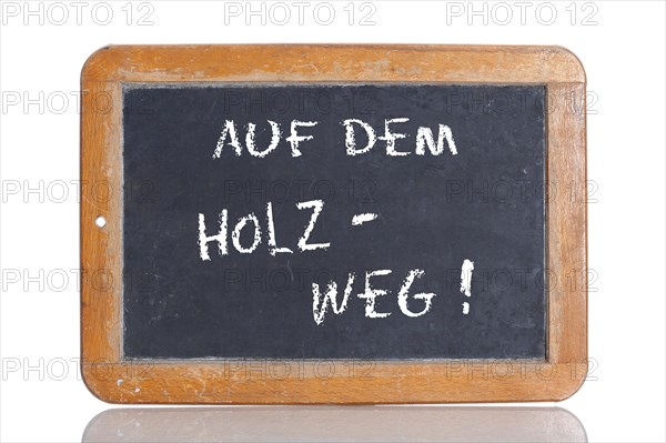 Old school blackboard with the term AUF DEM HOLZWEG
