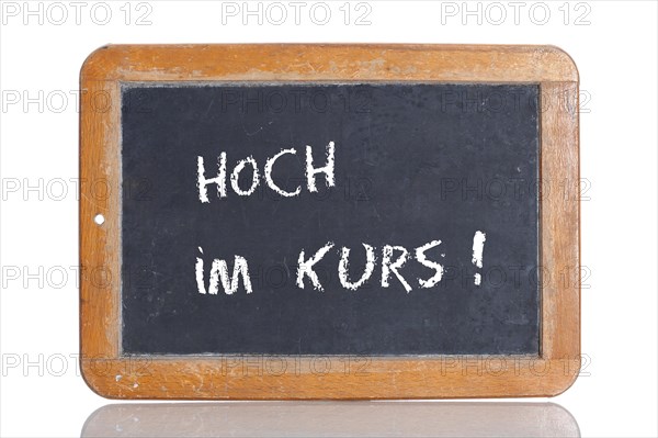 Old school blackboard with the term HOCH IM KURS