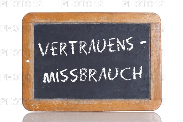 Old school blackboard with the term VERTRAUENSMISSBRAUCH