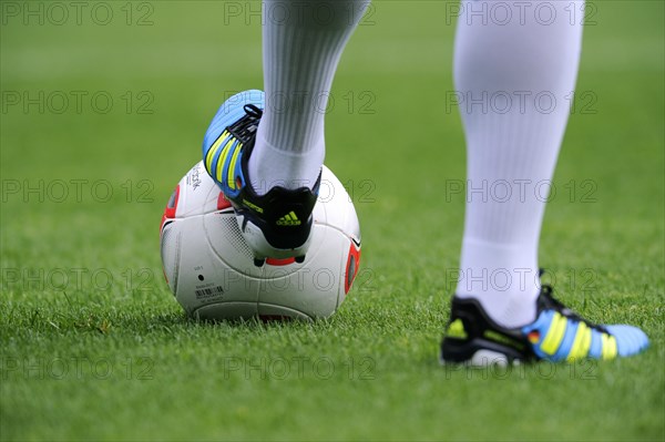 Players legs wearing adidas football boots and the adidas Torfabrik anniversary ball for the 50th Bundesliga season