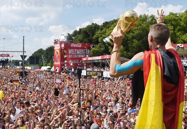 Bastian Schweinsteiger shows the fans the trophy