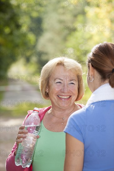 Women taking a break while doing sports outdoors