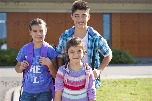 Children carrying school bags on the way to school