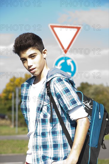 Boy carrying a school bag on the way to school