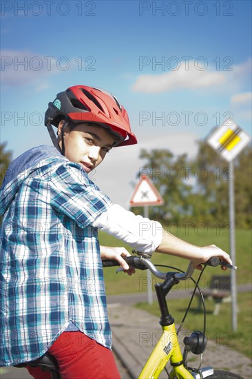 Boy wearing a bike helmet at a traffic awareness course