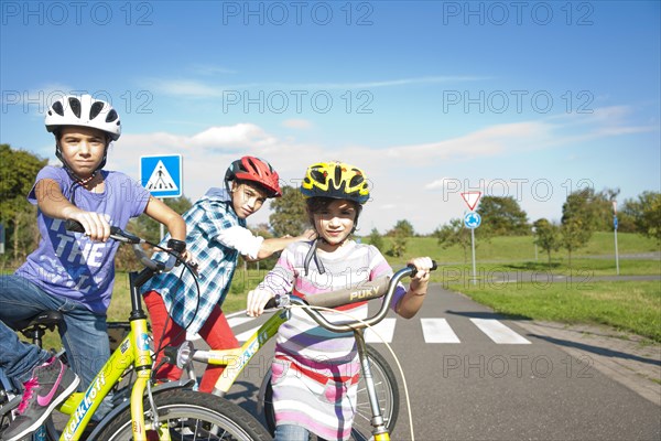 Children wearing bike helmets at a traffic awareness course