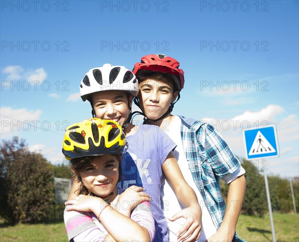 Children wearing bike helmets at a traffic awareness course