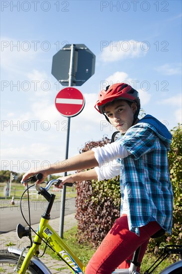 Boy wearing a bike helmet at a traffic awareness course