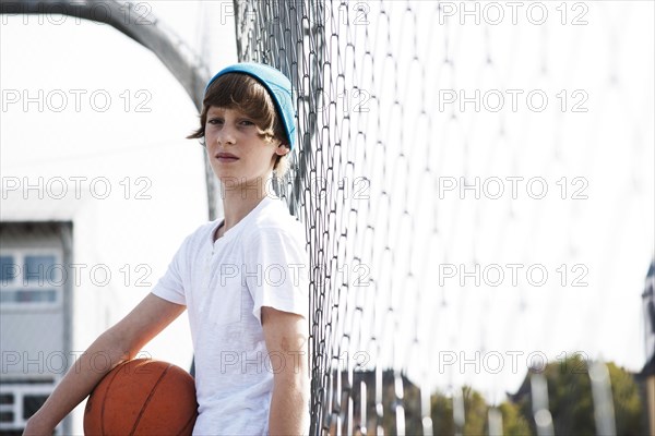 Cool boy holding a basketball