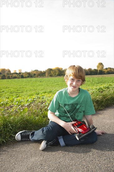 Boy playing with his radio-controlled model car