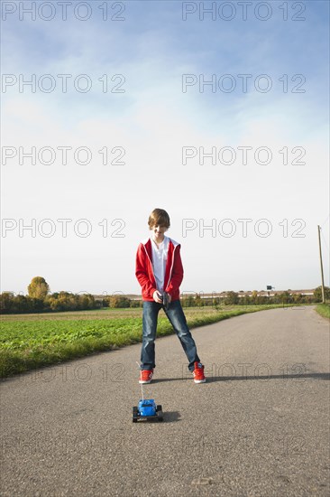 Boy playing with his radio-controlled model car