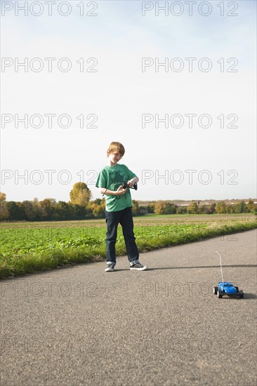 Boy playing with his radio-controlled model car