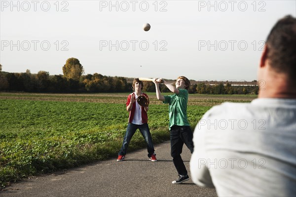 Father playing baseball with his sons