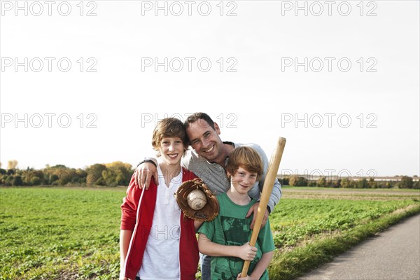 Father playing baseball with his sons