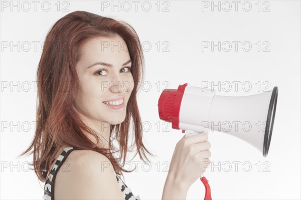 Young woman holding a megaphone