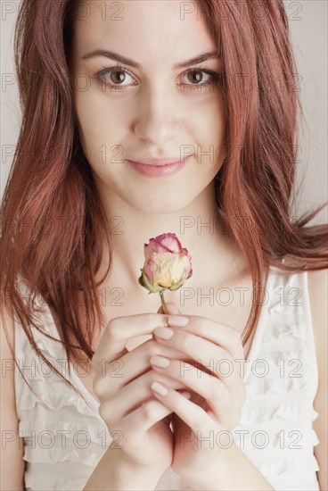 Young woman holding a rose