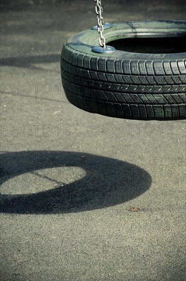 Empty swing made from a tyre at playground