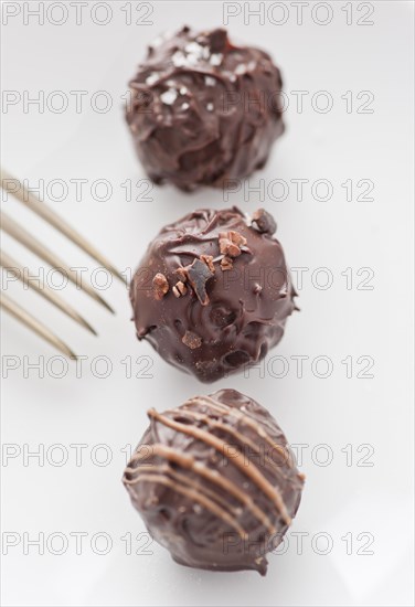 Three chocolate truffles and a fork