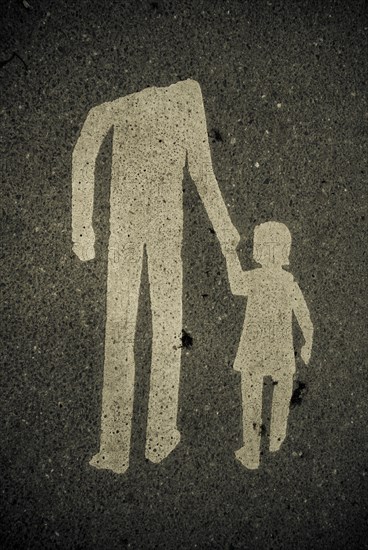 Weathered pictogramm with headless adult leading a child