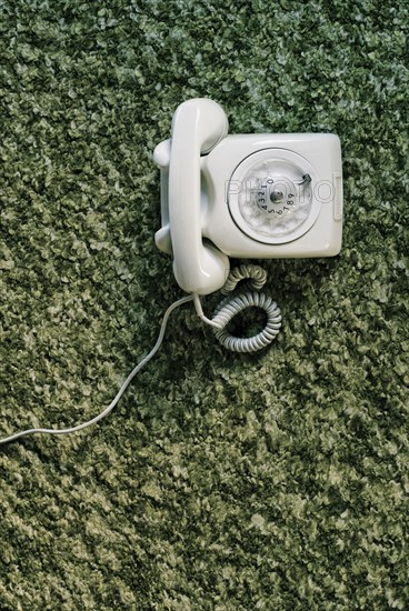 Old telephone on carpet