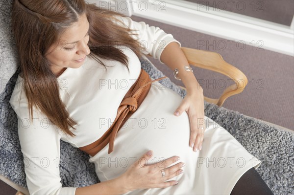Pregnant woman holding hands on her stomach