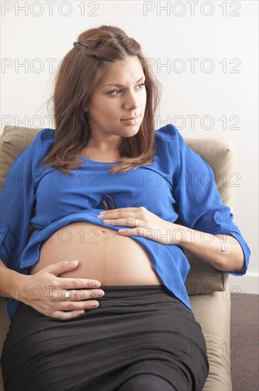 Pregnant woman holding hands on her stomach