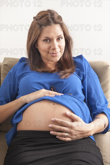 Pregnant woman holding hands on her stomach