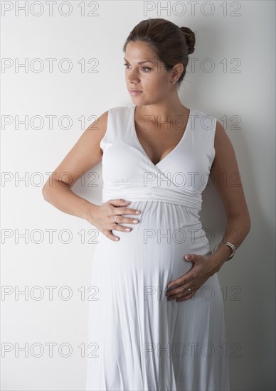 Pregnant woman holding hands on her stomach