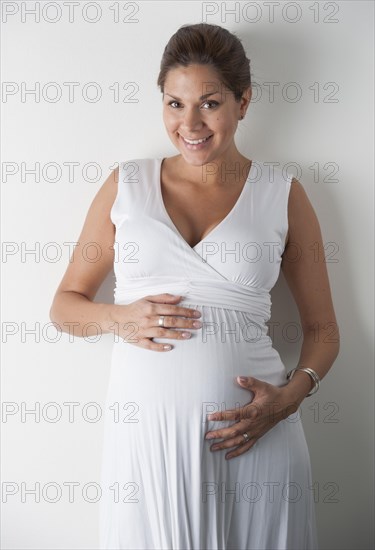 Pregnant woman holding hands on her stomach