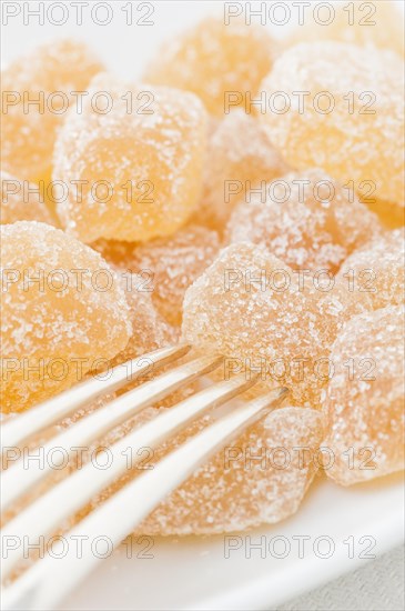 Dried ginger coated with sugar and a fork
