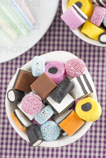 Bowls filled with liquorice candy and drinking straws