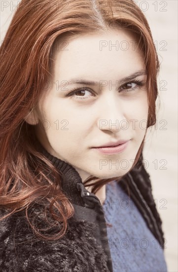 Portrait of a young woman with red hair