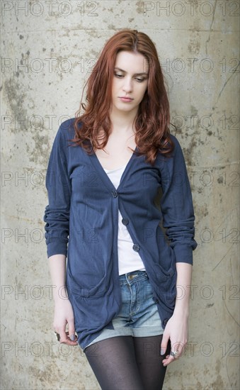 Pensive young woman with red hair