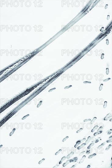 Tire tracks and footprints in snow