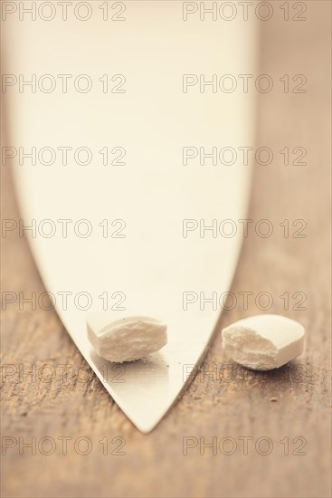 Medical capsule divided into two halves by large knife