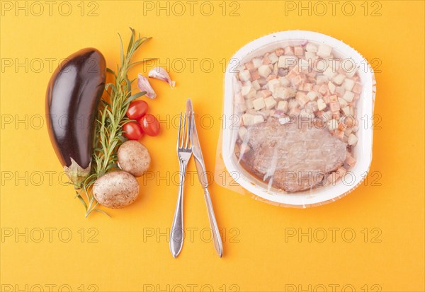 Fresh healthy vegetables next to microwave meal