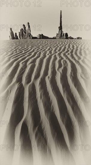 Sand dune in front of Totem Pole and Yei Bi Chei rock formations