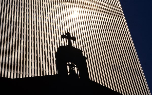 The St. Nicholas Greek Orthodox Church in front of a tower of the former World Trade Center or WTC