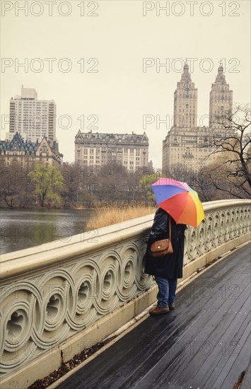 Woman with umbrella standing on Bow Bridge