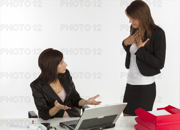 Two young women having a discussion in an office