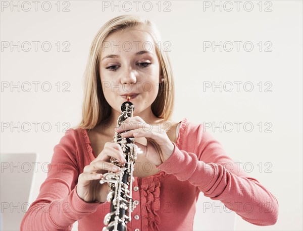 Teenage girl playing the oboe
