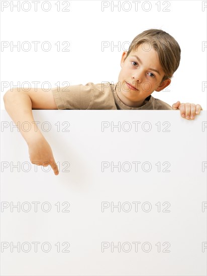 Schoolboy behind a white board