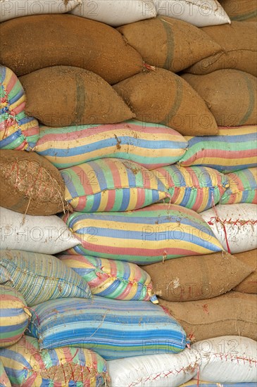 Plump bags of rice stacked in a rice warehouse