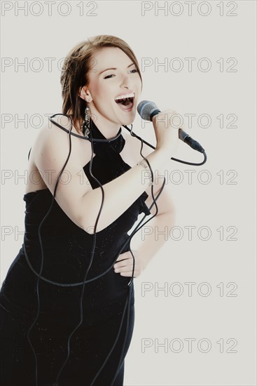 Woman singing into a microphone