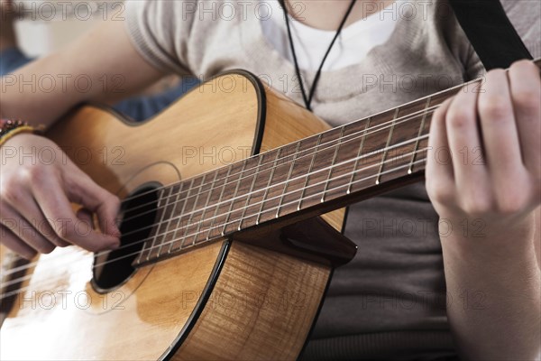 Teenage girl playing the guitar