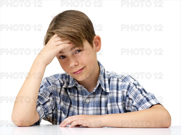 Boy with his hand supporting his head