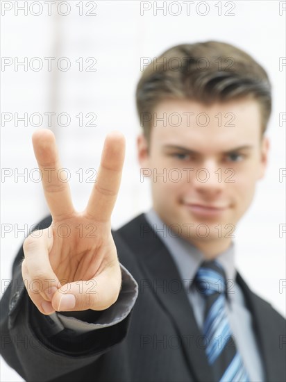 Businessman making a V-sign