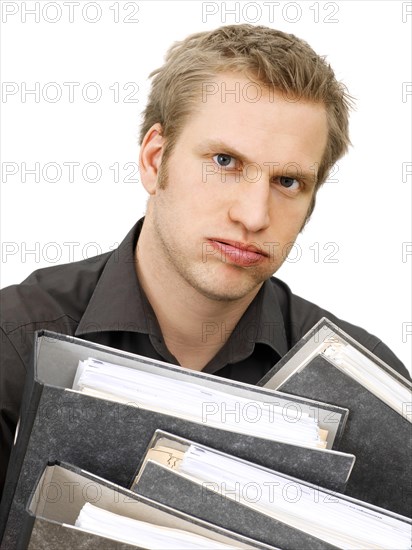 Businessman carrying ring binders